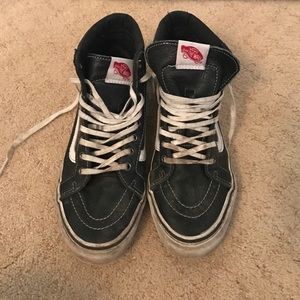 Black leather high-top vans.