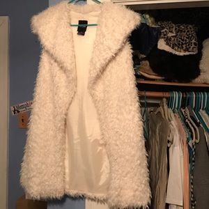 White faux fur vest.