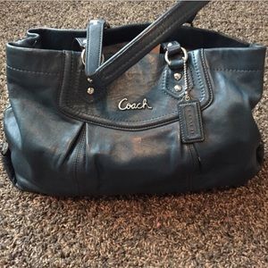 Coach handbag with strap, deep blue color.