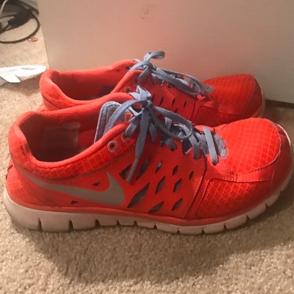 Bright orange Nike tennis shoes