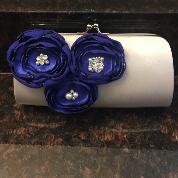 This is a new sliver & royal blue clutch.