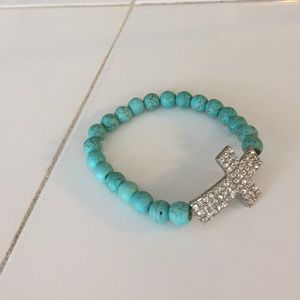 Cross bracelet with teal beads