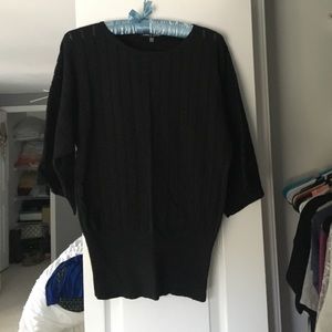 Black short sleeved sweater, fitted at bottom