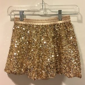 Gold sequined bubble mini skirt for girls.