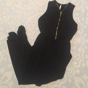 Black jumpsuit with gold zipper detail