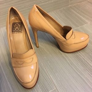 Beige patent leather covered platform.