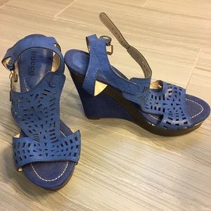 Blue wedge sandal with intricate cut out pattern.