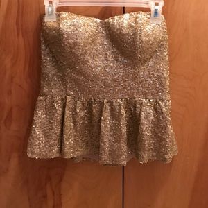 Gold sequin peplum tube top.