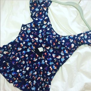 Floral top with crisscross back opening.