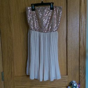 Gold sequin strapless dress.