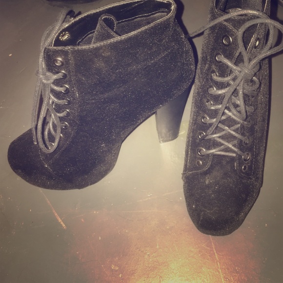 A pair of black suede boots