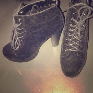 A pair of black suede boots