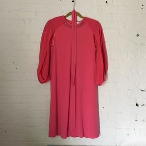 Formal dress with cape sleeves.