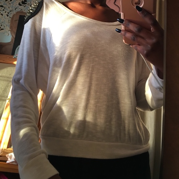 White sweater with black studded shoulder pads