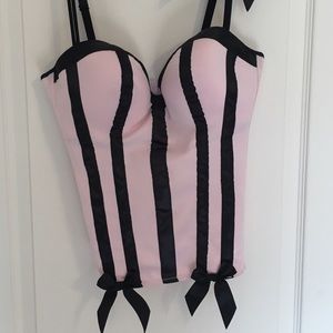 Pale pink and black corset with black bow detail.