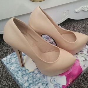Tan platform pumps with a red sole