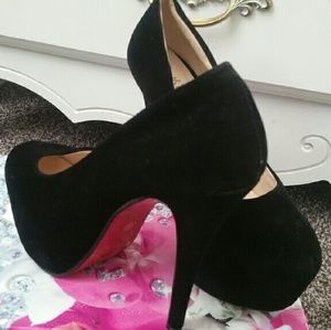 Black suede platform pumps with a red sole