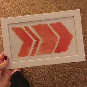 Coral and gold arrow painting with glass frame.