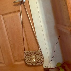 Small Coach crossbody purse.