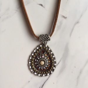 Suede necklace with pendant.