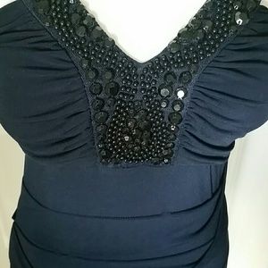 Dressy dress with a beaded neckline and straps.