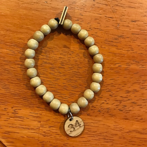 Tan Wood Beaded Bracelet with #34 on it.