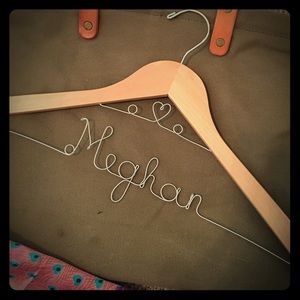 Engraved name wooden clothes hanger.