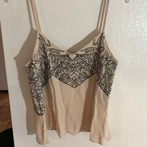 Cream tank top. Black stitching design