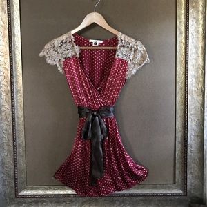 Silk blouse with lace details and silk sash.