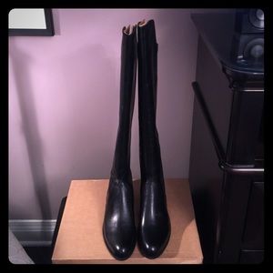 Black tall riding boots.