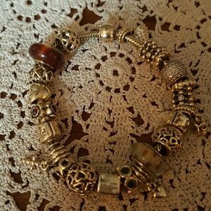 10k gold pandora braclet with 21 10k gold charms