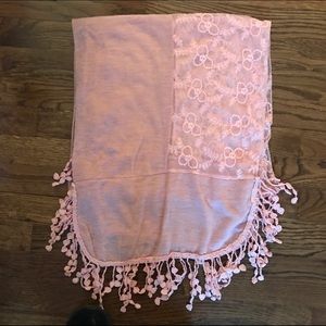 Pink scarf with tassels.