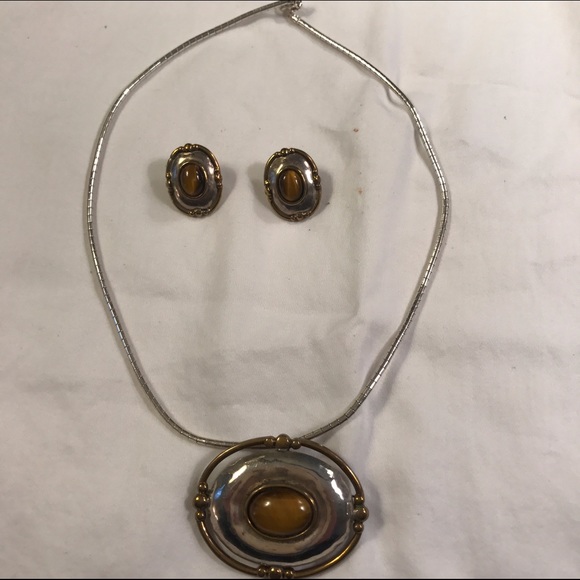 Silver necklace with matching earrings.