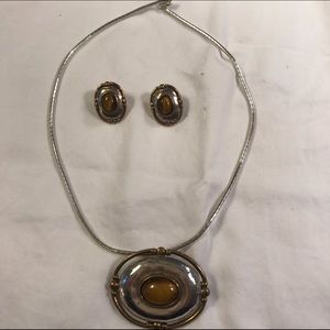 Silver necklace with matching earrings.