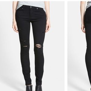 Distressed black skinny jeans