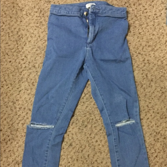 High waisted distressed blue jeans