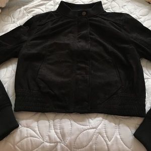 A black half jacket, stops near the belly button