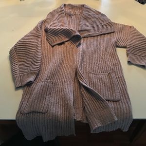 Long cozy sweater with collar and pockets.