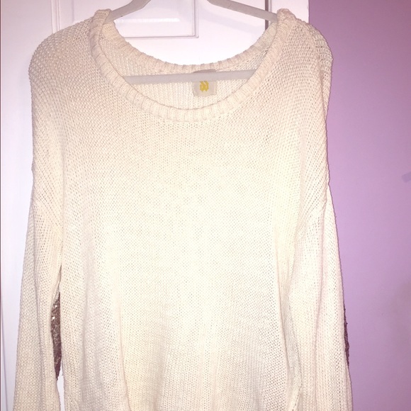 Women's white sweater with sparkly elbow patches.