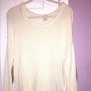 Women's white sweater with sparkly elbow patches.