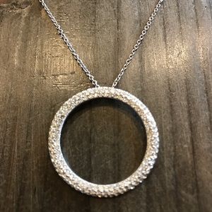 Silver necklace with sparkly ring pendant