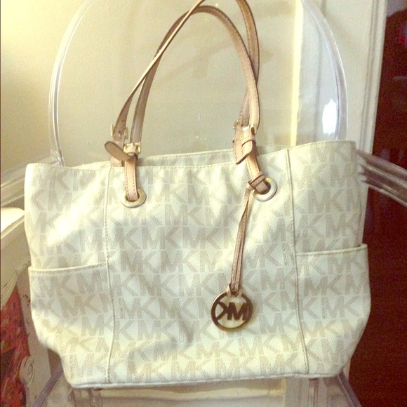 Michael Kors cream monogrammed shoulder bag.