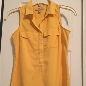 Yellow button down sleeveless blouse