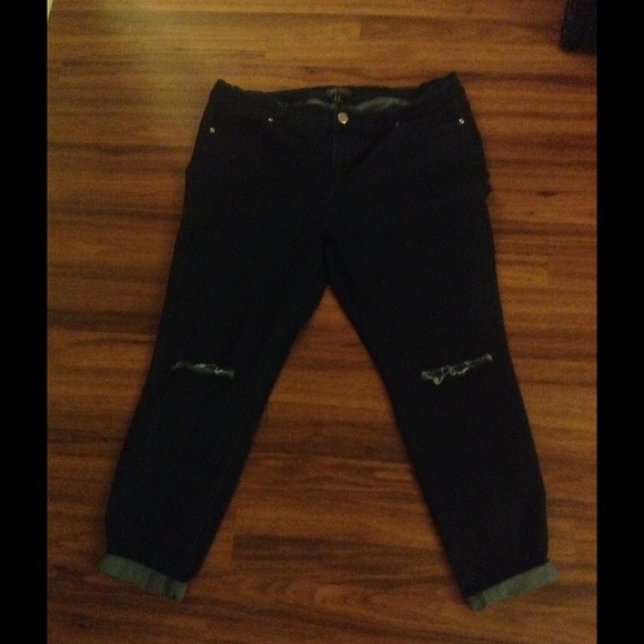 Distressed dark blue jeans