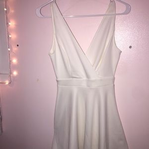 White dress with "V" cut in the back with bow.