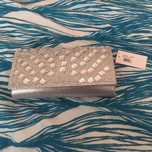 Selling a woman's silver and grey wallet clutch