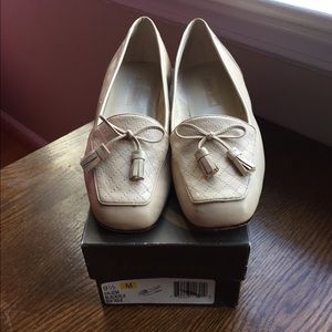 Cream colored loafers with tassels