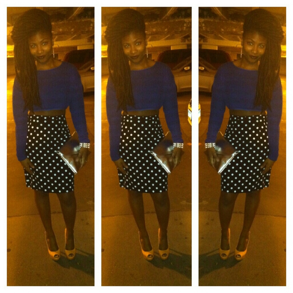 An polka-dot skirt and blue crop top