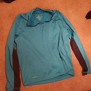 A blue Nike therma fit sweater