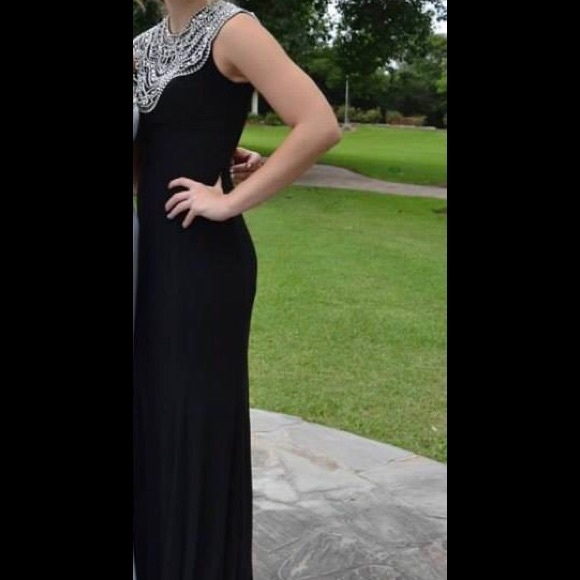 Long black dress with a beaded neckline.